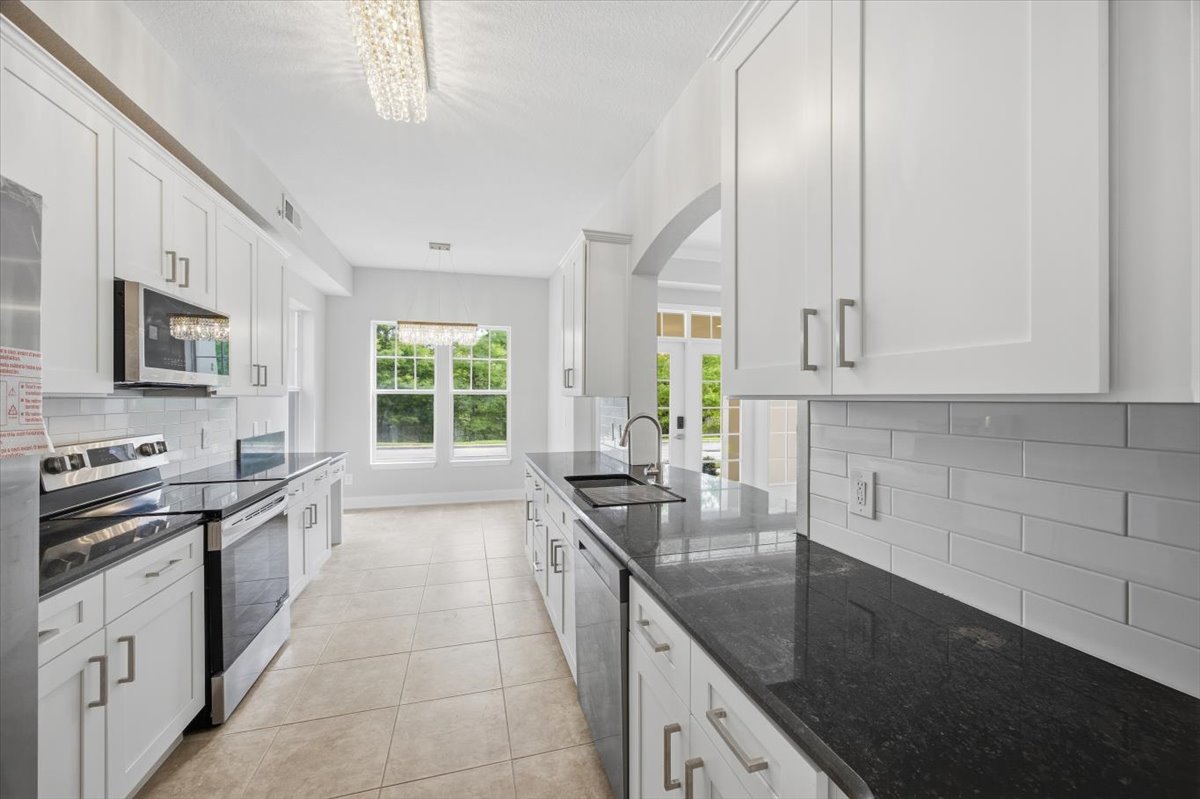 White shaker, granite, and all-new appliances