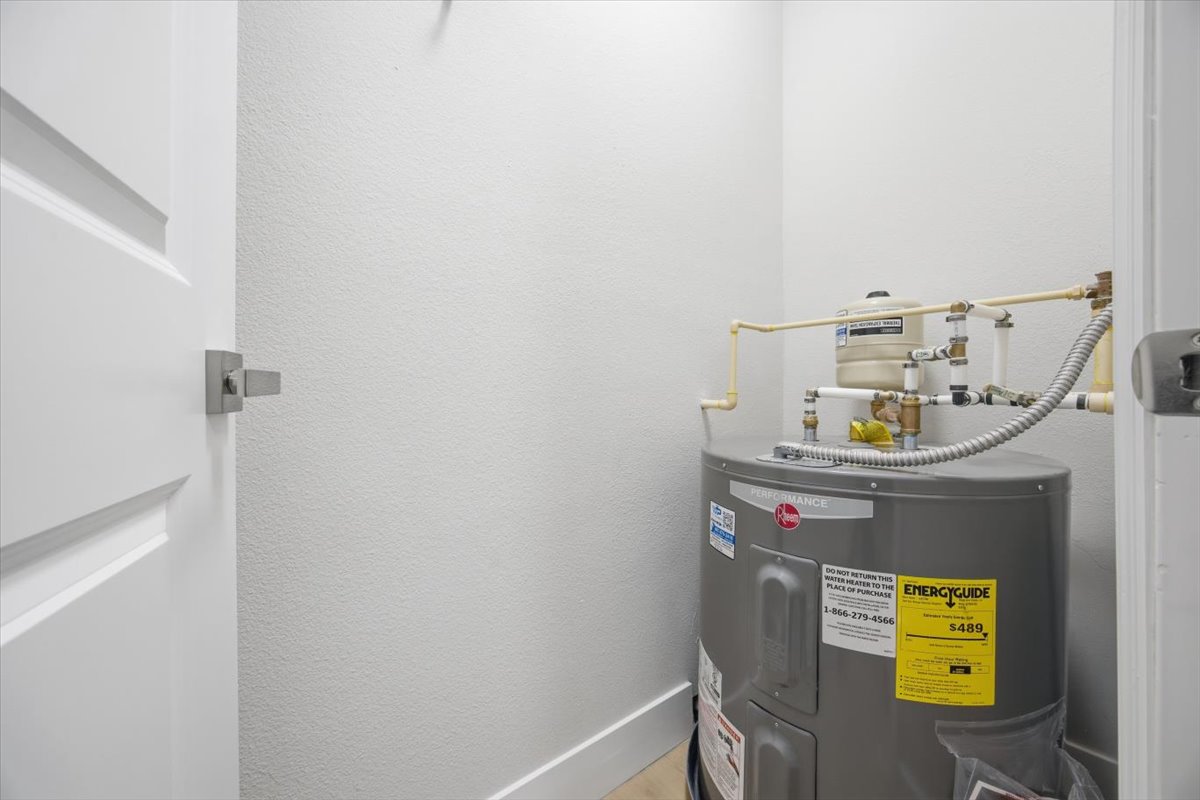 Dedicated utility closet housing a brand-new permitted water heater
